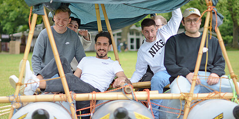 Apprentice team on a self-made raft