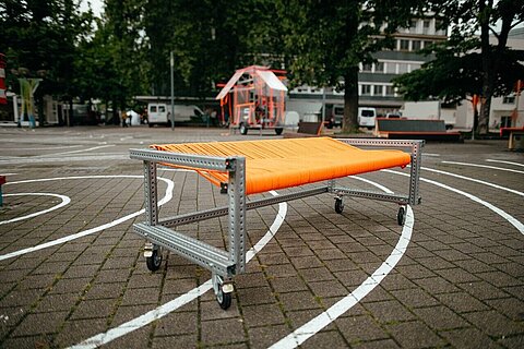 Bench with seat from orange charging cables from Coroflex