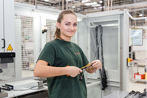Employee manufacturing wire harnesses